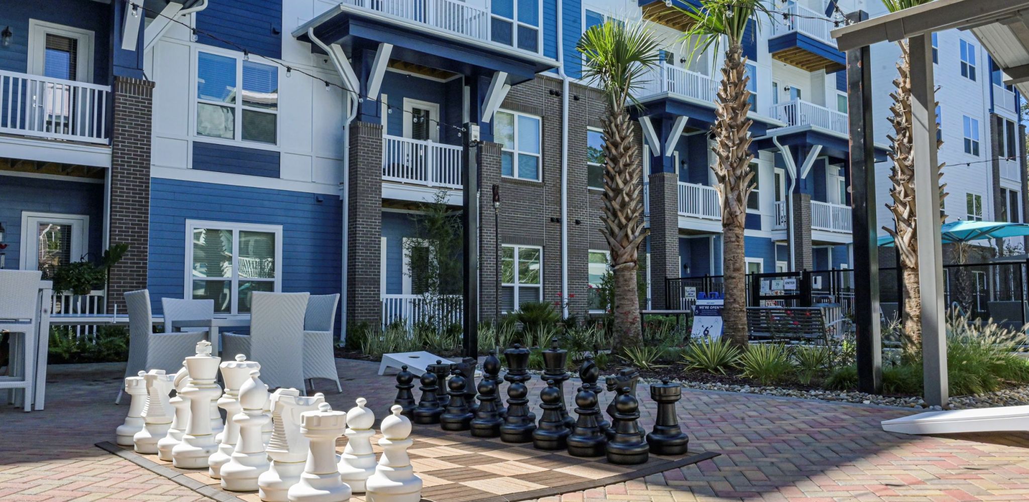 Hawthorne at Indy West outdoor area with jumbo chess game and surrounding seating and palm trees